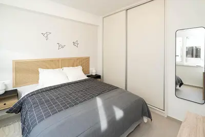 a bedroom with a bed and a mirror at Athens Urban Apartment in Athens