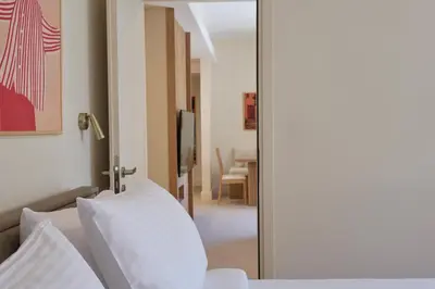 a room with a mirror and a bed and a table at Prestige Lifestyle 3bd Apt in Kolonaki in Athens
