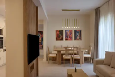 a living room and dining room with a table and chairs at Prestige Lifestyle 3bd Apt in Kolonaki in Athens