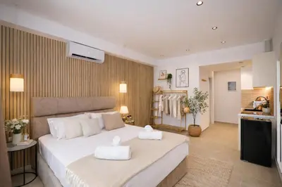 a bedroom with a large bed with towels on it at O Suite - 105 in Athens