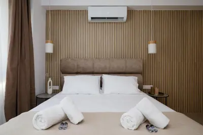a bedroom with a bed with towels on it at O Suite - 105 in Athens