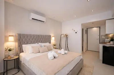 a bedroom with a large bed with two towels at O Suite - 106 in Athens