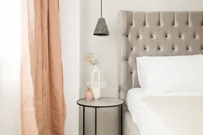a bedroom with a bed and a side table at O Suite - 106 in Athens