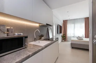a kitchen with a sink and a bed in a room at O Suite - 106 in Athens