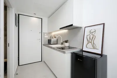 a kitchen with a sink and a microwave at O Suite - 106 in Athens