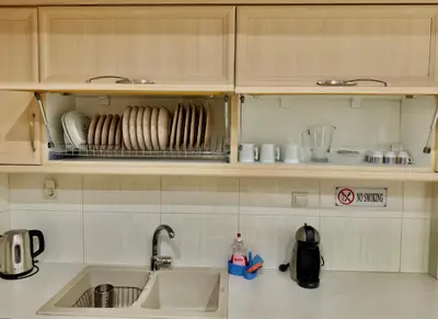 a kitchen with a sink and a counter with dishes at Marina Zeas Spacious Two Bedroom Apartment in Piraeus
