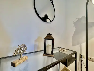 a glass table with a candle and a mirror at Marina Zeas Spacious Two Bedroom Apartment in Piraeus