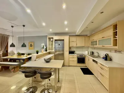 a large kitchen with wooden cabinets and counters at Marina Zeas Spacious Two Bedroom Apartment in Piraeus