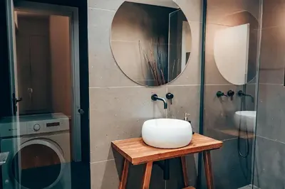 a bathroom with a sink and a washing machine at 4 guests apartment near Glyfada center in Athens