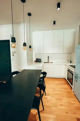 a kitchen with a black table and chairs at 4 guests apartment near Glyfada center in Athens