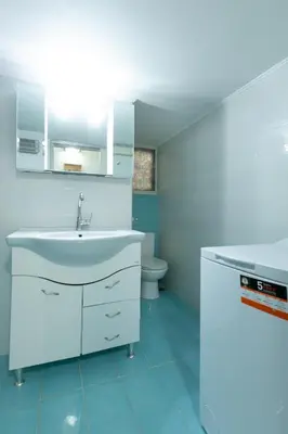 a white bathroom with a sink and a toilet at Athens center traditional & classic 2BR apartment in Mesochórion