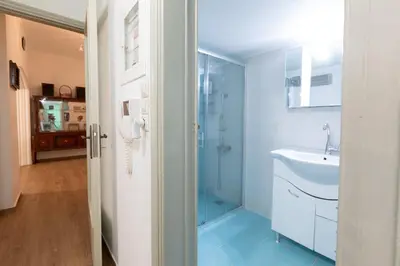 a bathroom with a glass shower and a sink at Athens center traditional & classic 2BR apartment in Mesochórion