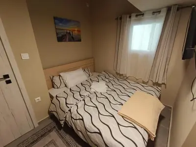 a bed in a small room with a window at knezevic resorts 14 in Athens