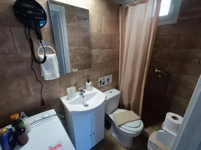 a bathroom with a sink and a toilet and a mirror at knezevic resorts 14 in Athens
