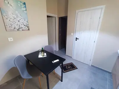 a black table and chairs in a room with a door at knezevic resorts 14 in Athens