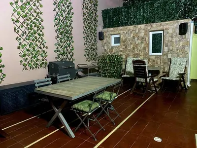 a table and chairs in a room with a wall at knezevic resorts 14 in Athens