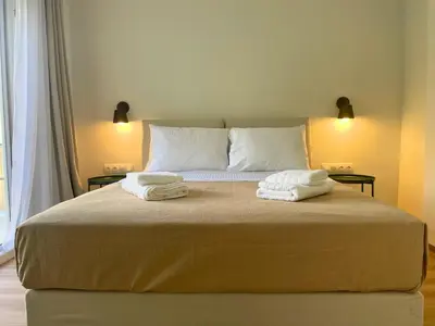 a bedroom with a bed with two towels on it at Quiet Central 2-bedroom Flat 4' to Metro & Shops in Athens