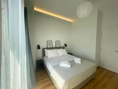 a bedroom with a white bed and a window at Quiet Central 2-bedroom Flat 4' to Metro & Shops in Athens