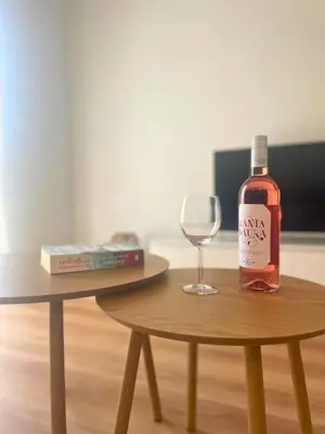 a bottle of wine sitting on a table next to a wine glass at Quiet Central 2-bedroom Flat 4' to Metro & Shops in Athens