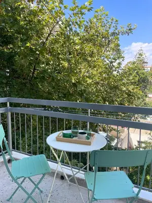 a table and two chairs on a balcony at Quiet Central 2-bedroom Flat 4' to Metro & Shops in Athens
