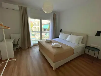 a bedroom with a bed and a large window at Quiet Central 2-bedroom Flat 4' to Metro & Shops in Athens