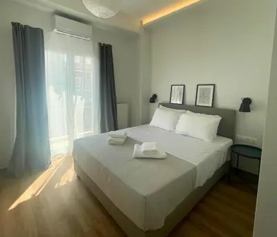 a bedroom with a bed with two towels on it at Quiet Central 2-bedroom Flat 4' to Metro & Shops in Athens