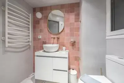 a bathroom with a sink and a mirror at The Courtyard Oasis in Athens