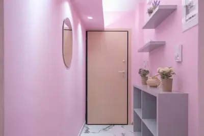 a pink bathroom with a door and a mirror at The Courtyard Oasis in Athens