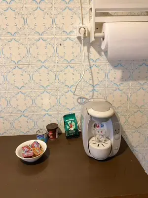 a small appliance sitting on a table next to a plate of food at Sunset apartment Saronida by the sea with stunning view in Saronida