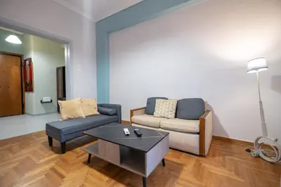 a living room with a couch and a coffee table at Athenian Getaway near Metro-Agios Nikolaos by ΜΡS in Athens