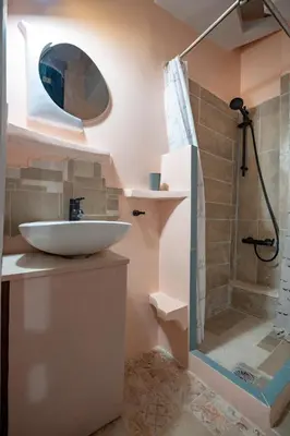 a bathroom with a sink and a shower at Athenian Getaway near Metro-Agios Nikolaos by ΜΡS in Athens