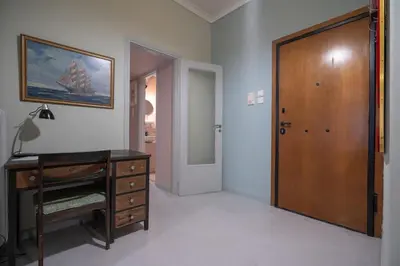 a room with a wooden dresser and a wooden door at Athenian Getaway near Metro-Agios Nikolaos by ΜΡS in Athens