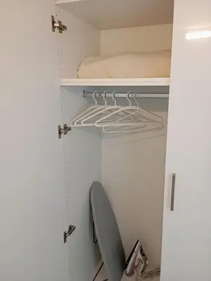 a closet with a bed and a chair in it at Anemelia & Helios Studio in Anavissos