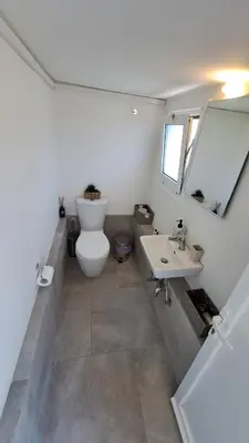 a bathroom with a toilet and a sink at Anemelia & Helios Studio in Anavissos