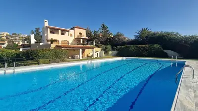 a large swimming pool in front of a house at Villa Almy - shared pool with 1 house in Anavissos