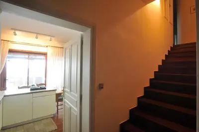 a stairway leading to a room with orange walls at Villa Almy - shared pool with 1 house in Anavissos