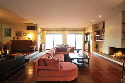 a living room with a couch and a fireplace at Villa Almy - shared pool with 1 house in Anavissos