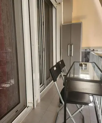 a glass table and a chair in a room with a window at Elegant-Quiet 2' Metro Center in Athens