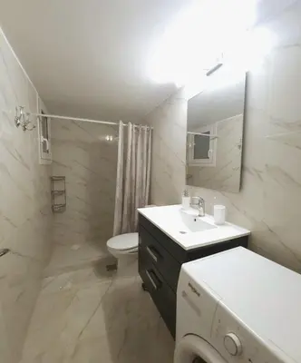 a bathroom with a sink and a toilet and a mirror at Elegant-Quiet 2' Metro Center in Athens