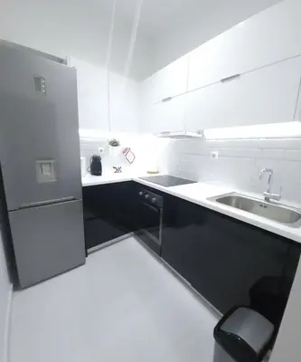 a white kitchen with a sink and a refrigerator at Elegant-Quiet 2' Metro Center in Athens