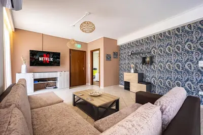 a living room with a couch and a table at Komis House - Cozy Stay near Metro in Athens