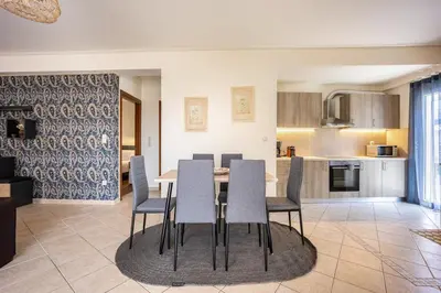 a kitchen and dining room with a table and chairs at Komis House - Cozy Stay near Metro in Athens