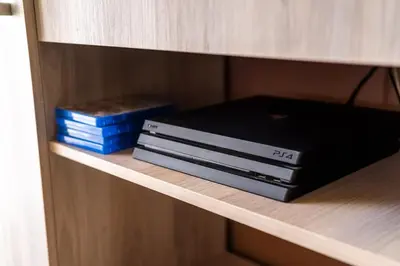 a shelf with two dvds and a box on it at Komis House - Cozy Stay near Metro in Athens