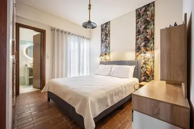 a bedroom with a bed and a large window at Komis House - Cozy Stay near Metro in Athens