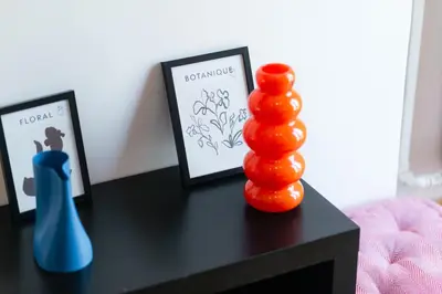 a table with pictures and a vase on it at Athens Vibes City Studio in Athens