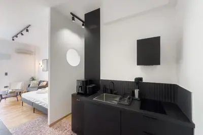 a kitchen with a sink and a bed in a room at Athens Vibes City Studio in Athens