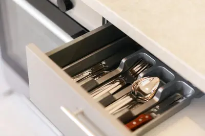 a drawer with silver utensils in a kitchen at Urban Apartment on Top with View in Athens