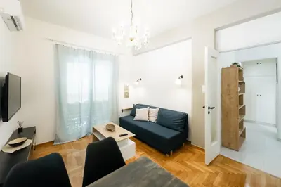 a living room with a couch and a table at My Athens Home near Metro Station in Athens