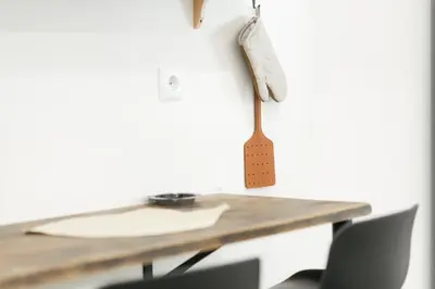 a wooden spoon hanging on a wall next to a table at My Athens Home near Metro Station in Athens