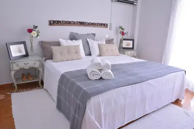a bedroom with a bed with two towels on it at Detached House 4km away from Acropolis & Riviera in Athens